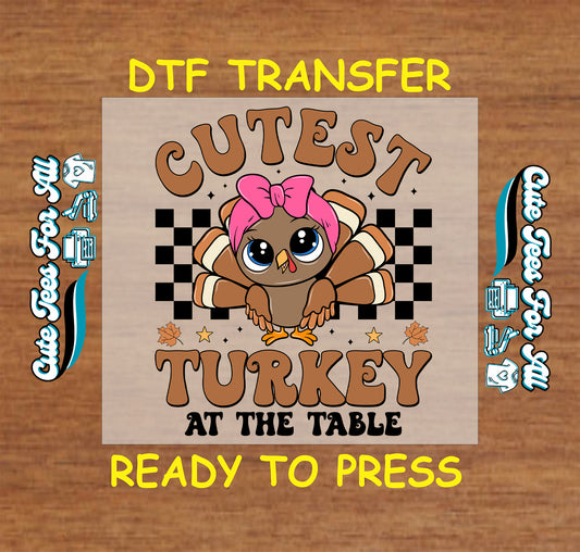 Cutest Turkey at the Table text with pink bow cartoon turkey Thanksgiving ready to press dtf transfer for DIY shirts.
