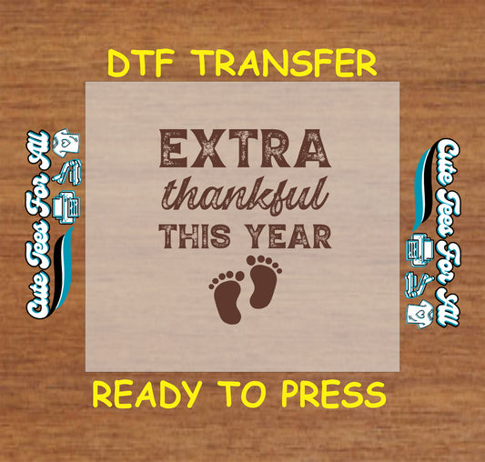 Thanksgiving ready to press dtf transfer with “Extra Thankful This Year” text and baby footprints