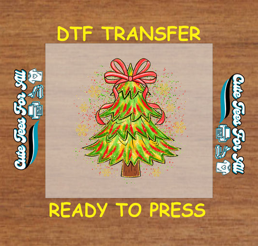 Christmas DTF transfer with green holiday tree, red bow topper, and colorful splatter background, ready to press dtf heat transfer for diy shirts