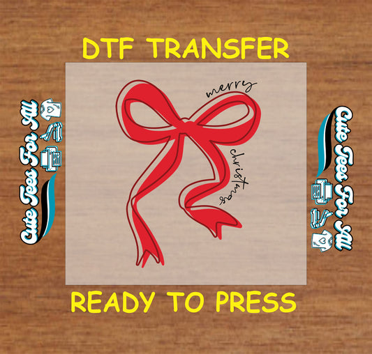 Christmas ready to press DTF transfer with red bow and handwritten script that says Merry Christmas.