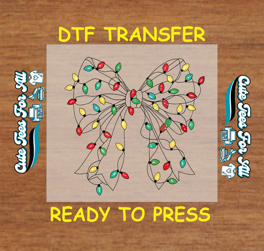 Christmas ready to press DTF transfer with a bow made of colorful Christmas lights in red, green, yellow, and blue.