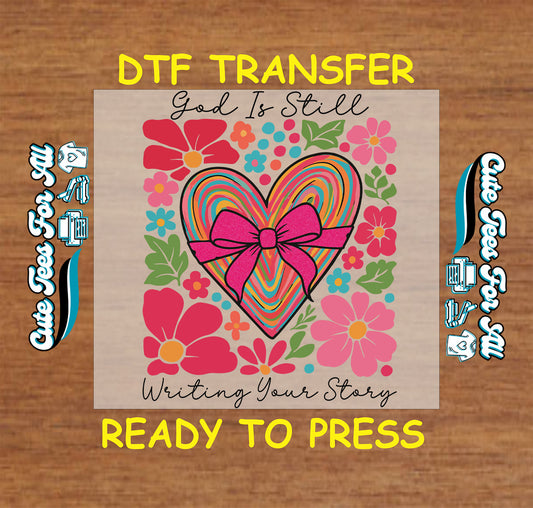 God Is Still Writing Your Story ready to press DTF transfer with rainbow heart, pink bow, and colorful floral accents