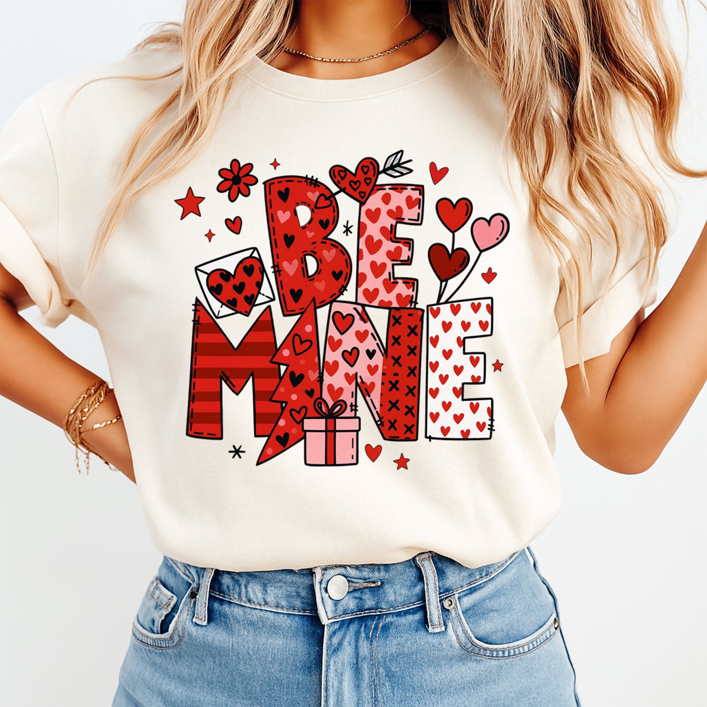Ready to press dtf Be Mine Valentine transfer shown pressed on a shirt, featuring bold heart typography and festive love details
