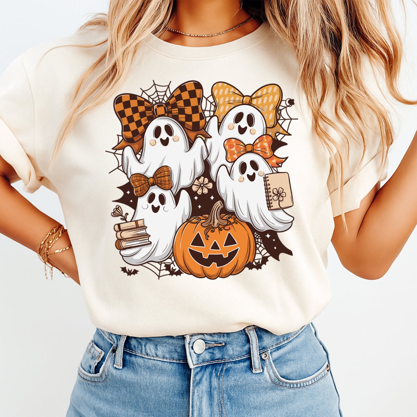 Halloween ghost shirt mockup showing stacked ghost illustration with bows pumpkin and autumn accents on light colored tee