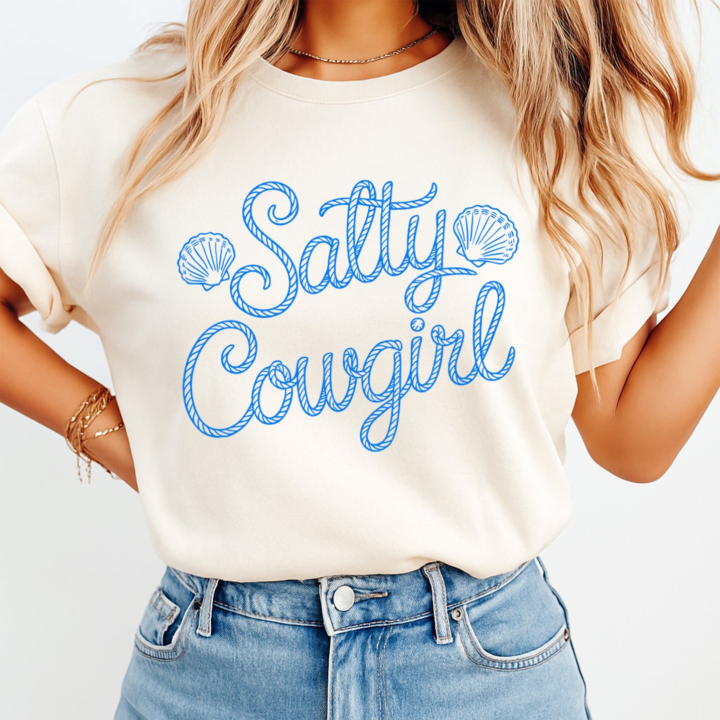 Woman wearing salty cowgirl beach shirt with rope script coastal design