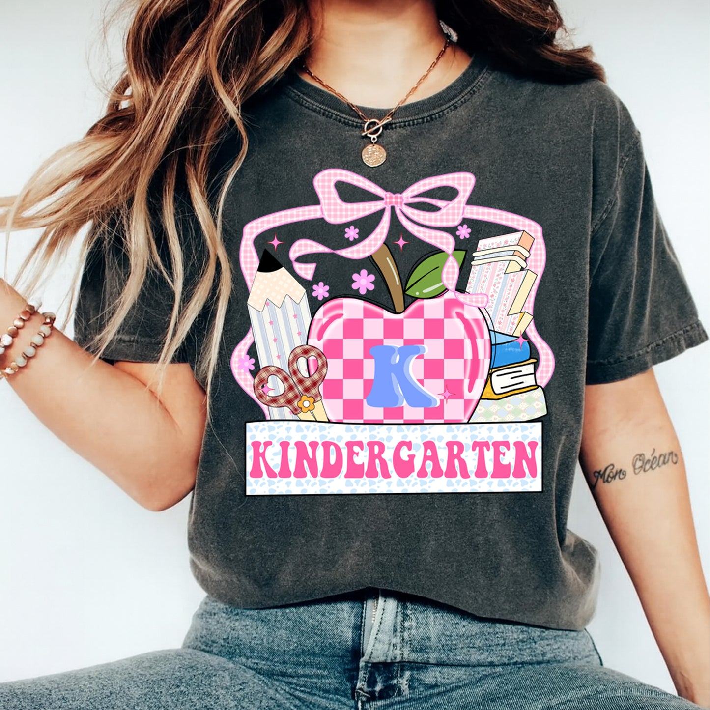 Kindergarten apple graphic printed on shirt mockup featuring pink bow gingham apple and classroom themed artwork