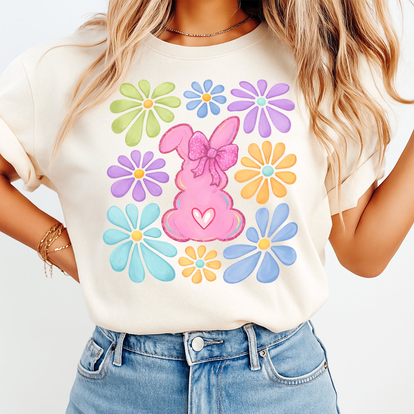 woman wearing beige shirt with pink bunny dtf transfer surrounded by colorful flowers and spring theme design