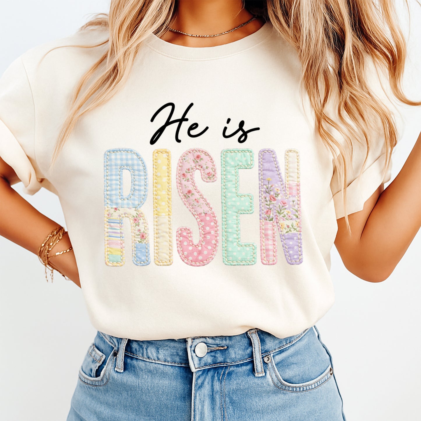 woman wearing beige shirt with he is risen dtf transfer featuring pastel patchwork letters and floral accents