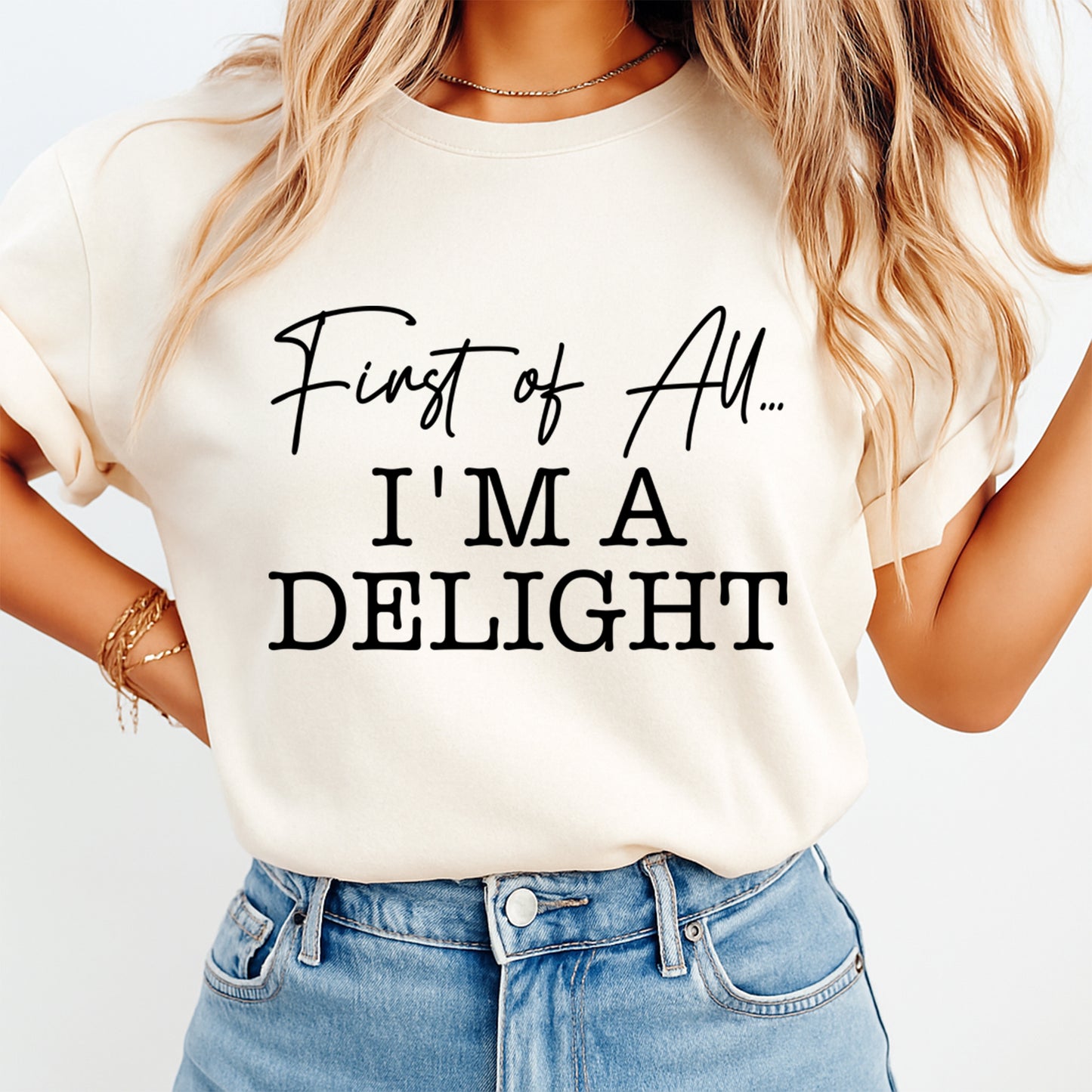 Cream shirt mockup featuring a funny ready to press dtf transfer with the phrase First of All I’m a Delight in bold black lettering.
