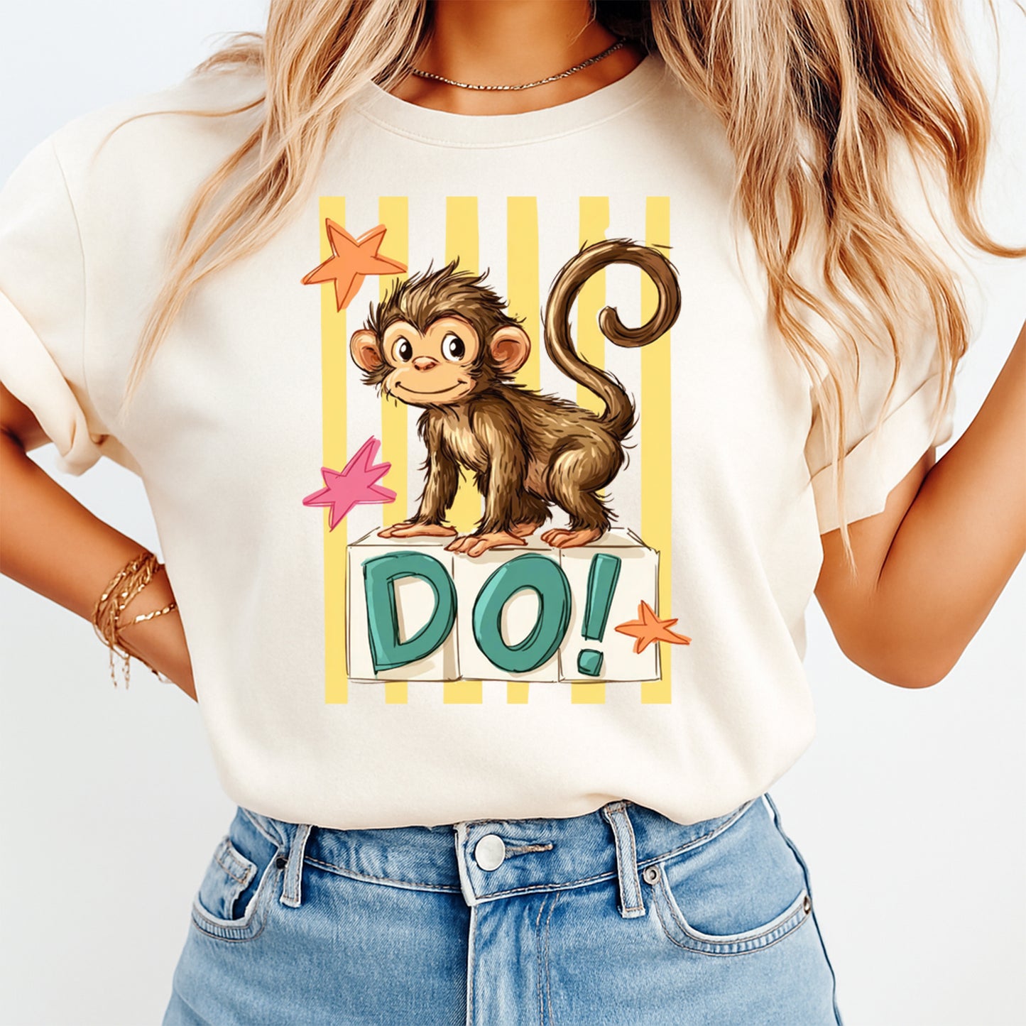 Person wearing a white t-shirt with a monkey graphic and 'DO!' text on a plain background