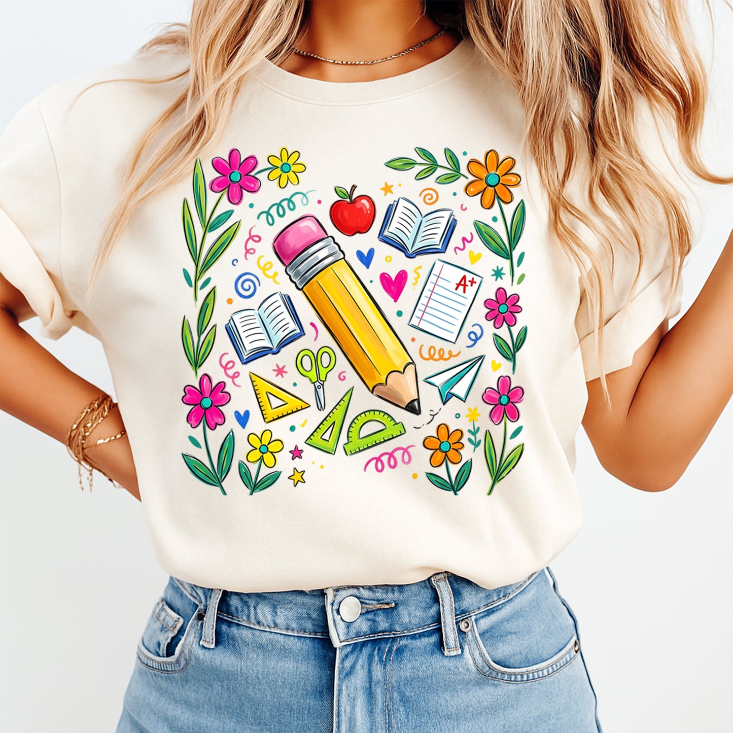 Person wearing a white t-shirt with colorful school-themed graphics on a plain background