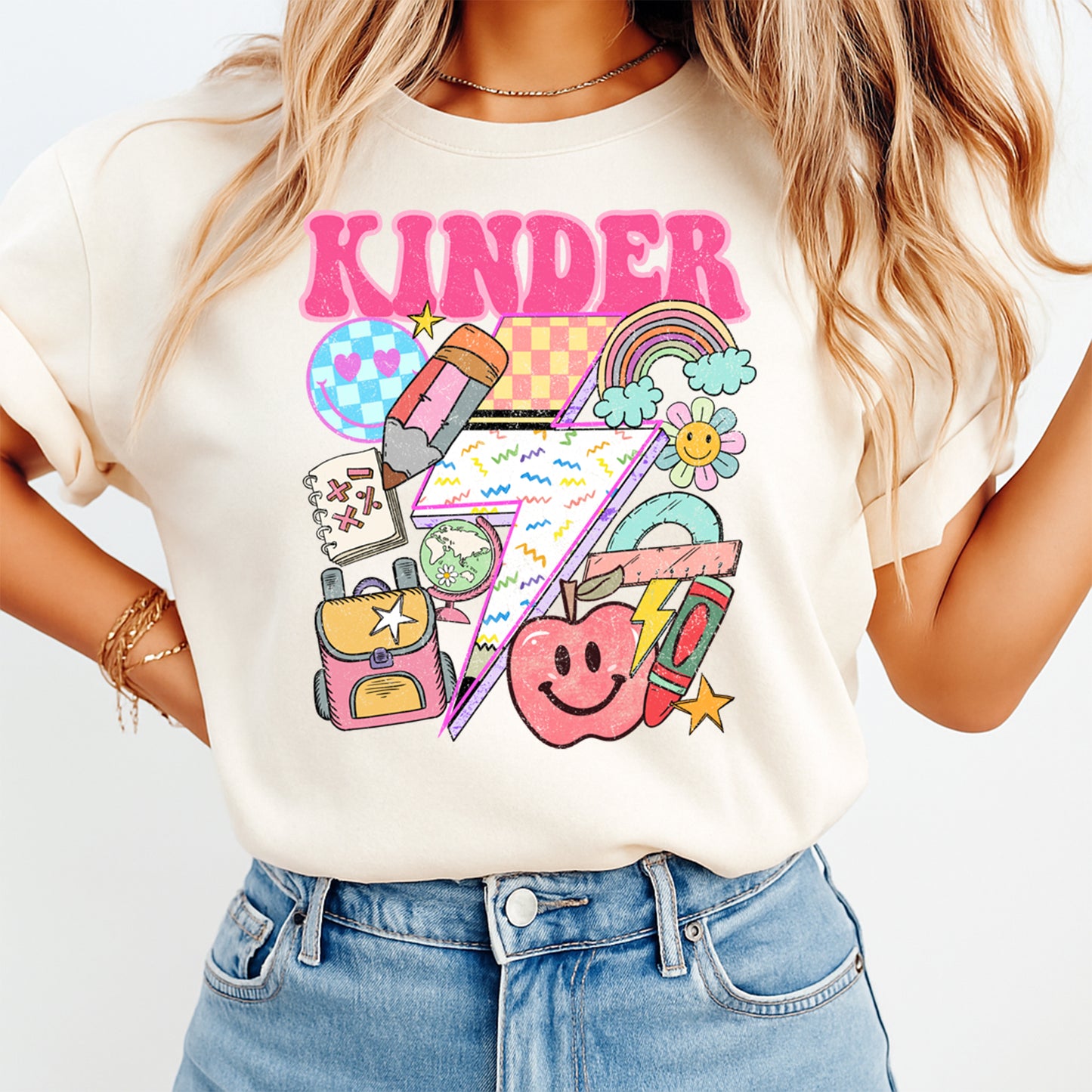 Person wearing a white t-shirt with 'KINDER' and educational graphics on a plain background