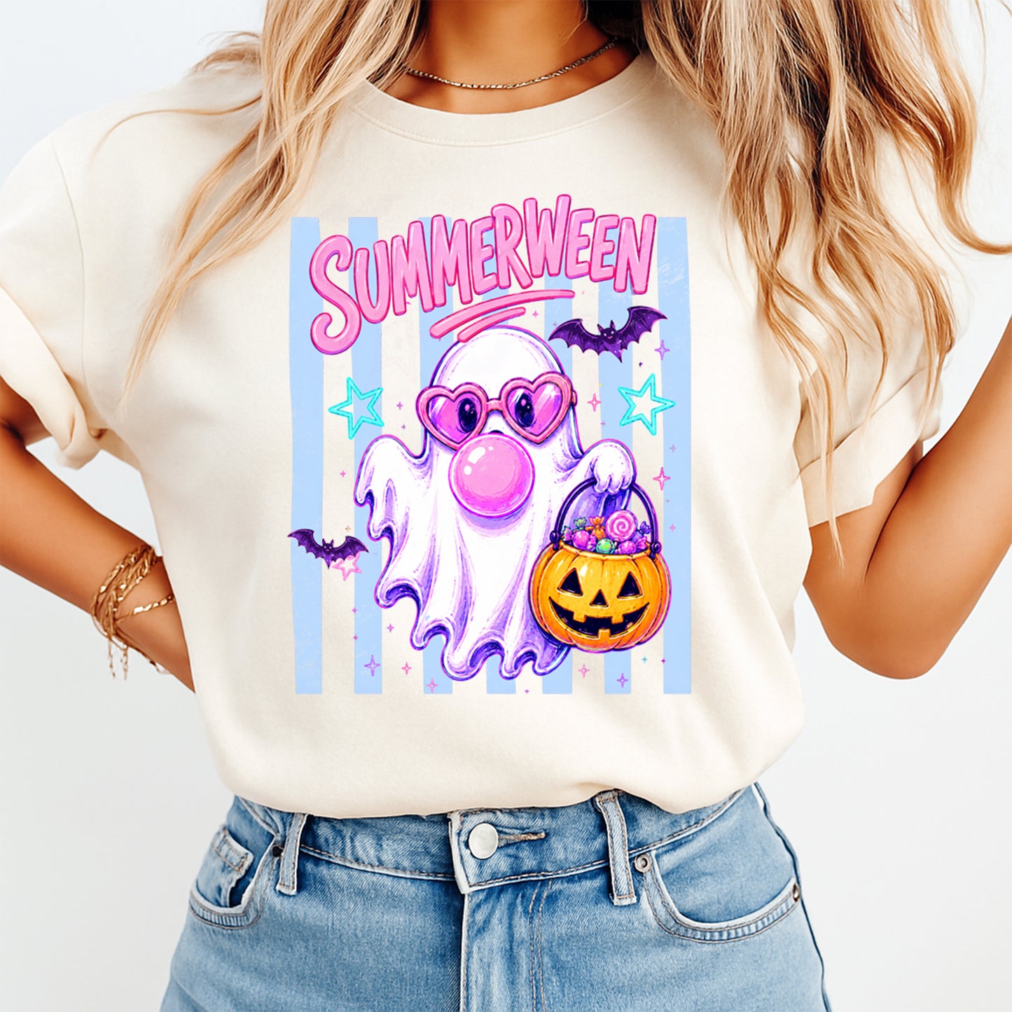 Person wearing a t-shirt with 'Summerween' design featuring a ghost, candy, and pumpkins.