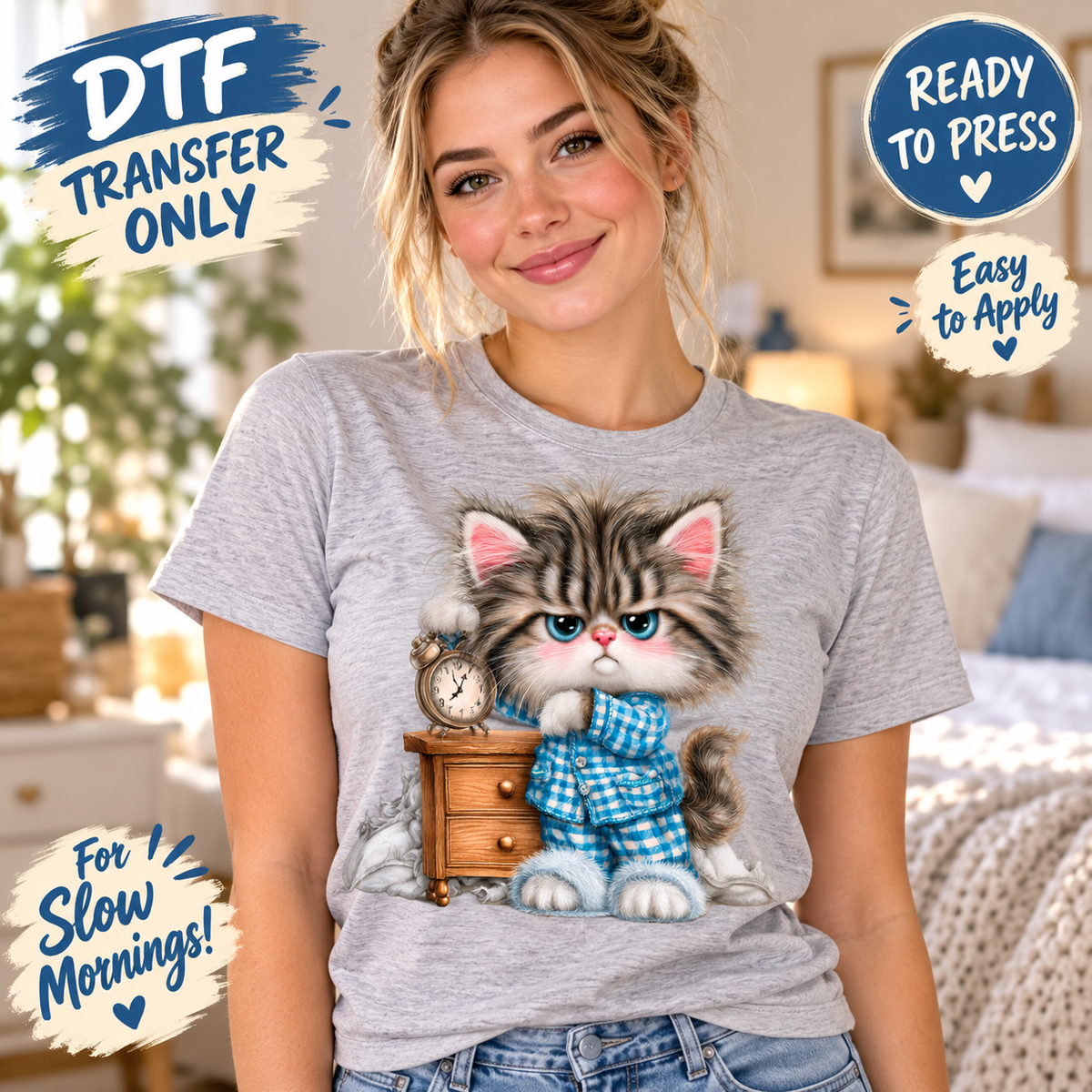 A woman wearing a light gray heather t-shirt with a graphic of a fluffy gray kitten in a blue plaid shirt sitting next to a wooden nightstand and clock. The image contains promotional text overlays: 'DTF TRANSFER ONLY', 'READY TO PRESS', 'Easy to Apply', and 'For Slow Mornings!'.