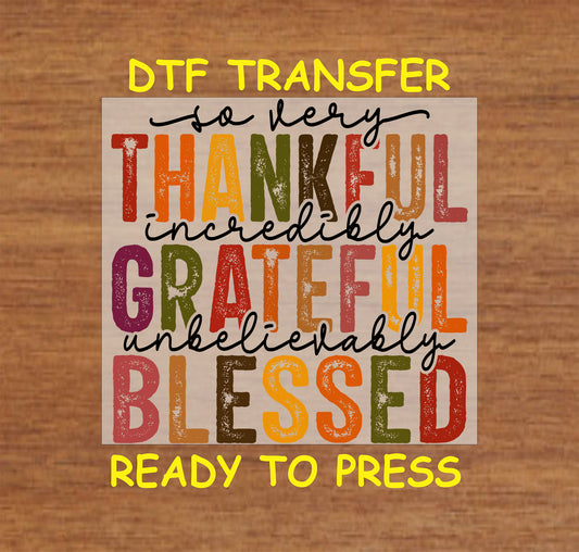 Thanksgiving-themed DTF transfer with the phrases "So Very Thankful, Grateful, and Blessed" in colorful autumn tones.
