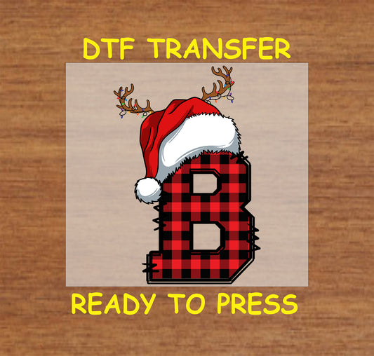 DTF transfer featuring a buffalo plaid letter "B" adorned with a Santa hat and reindeer antlers, perfect for custom Christmas apparel or gifts.