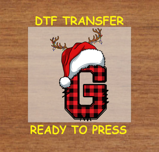 DTF transfer featuring a buffalo plaid letter "G" adorned with a Santa hat and reindeer antlers, perfect for custom Christmas gifts and apparel.