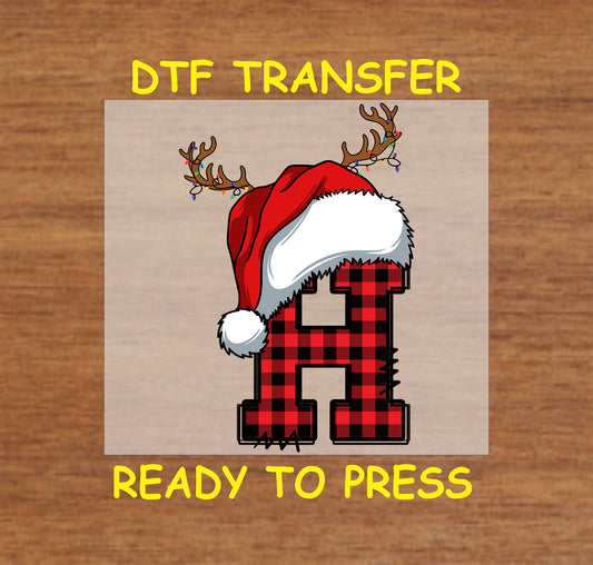 DTF transfer featuring a buffalo plaid letter "H" adorned with a Santa hat and reindeer antlers, perfect for festive holiday apparel and custom gifts.