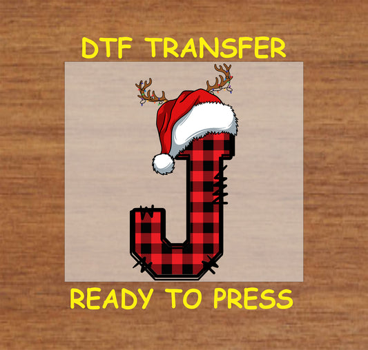 DTF transfer featuring a buffalo plaid letter "J" adorned with a Santa hat and reindeer antlers, ideal for creating festive apparel and custom Christmas gifts.