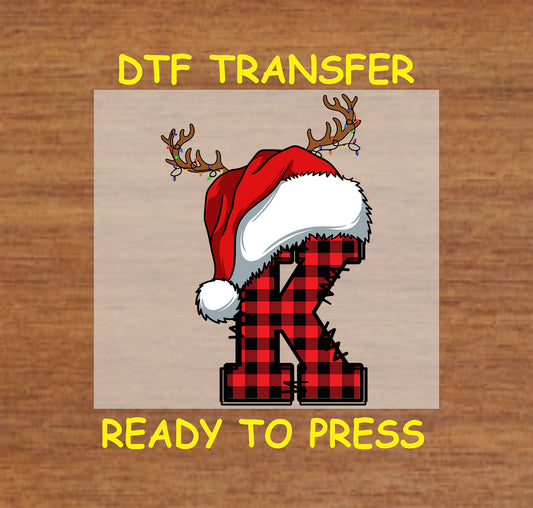 DTF transfer featuring a buffalo plaid letter "K" adorned with a Santa hat and reindeer antlers, ideal for creating festive apparel and custom Christmas gifts.
