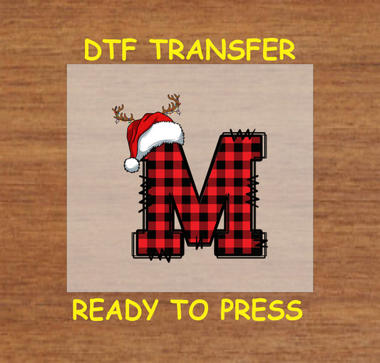 DTF transfer featuring a buffalo plaid letter "M" adorned with a Santa hat and reindeer antlers, perfect for festive holiday apparel and Christmas crafting.