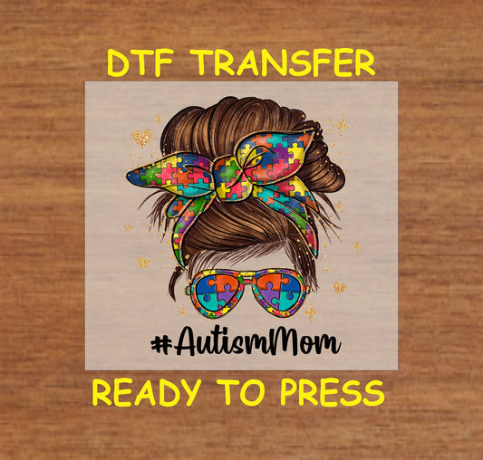 Puzzle-patterned bow and sunglasses with #AutismMom text, perfect for autism awareness apparel.