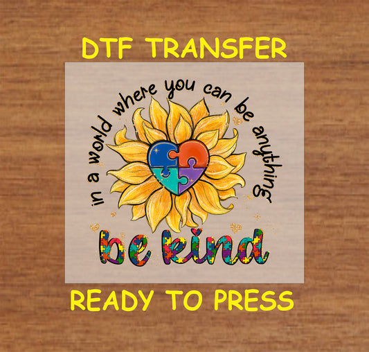 Vibrant sunflower with a puzzle-piece heart and "Be Kind" message, colorful autism awareness DTF transfer.