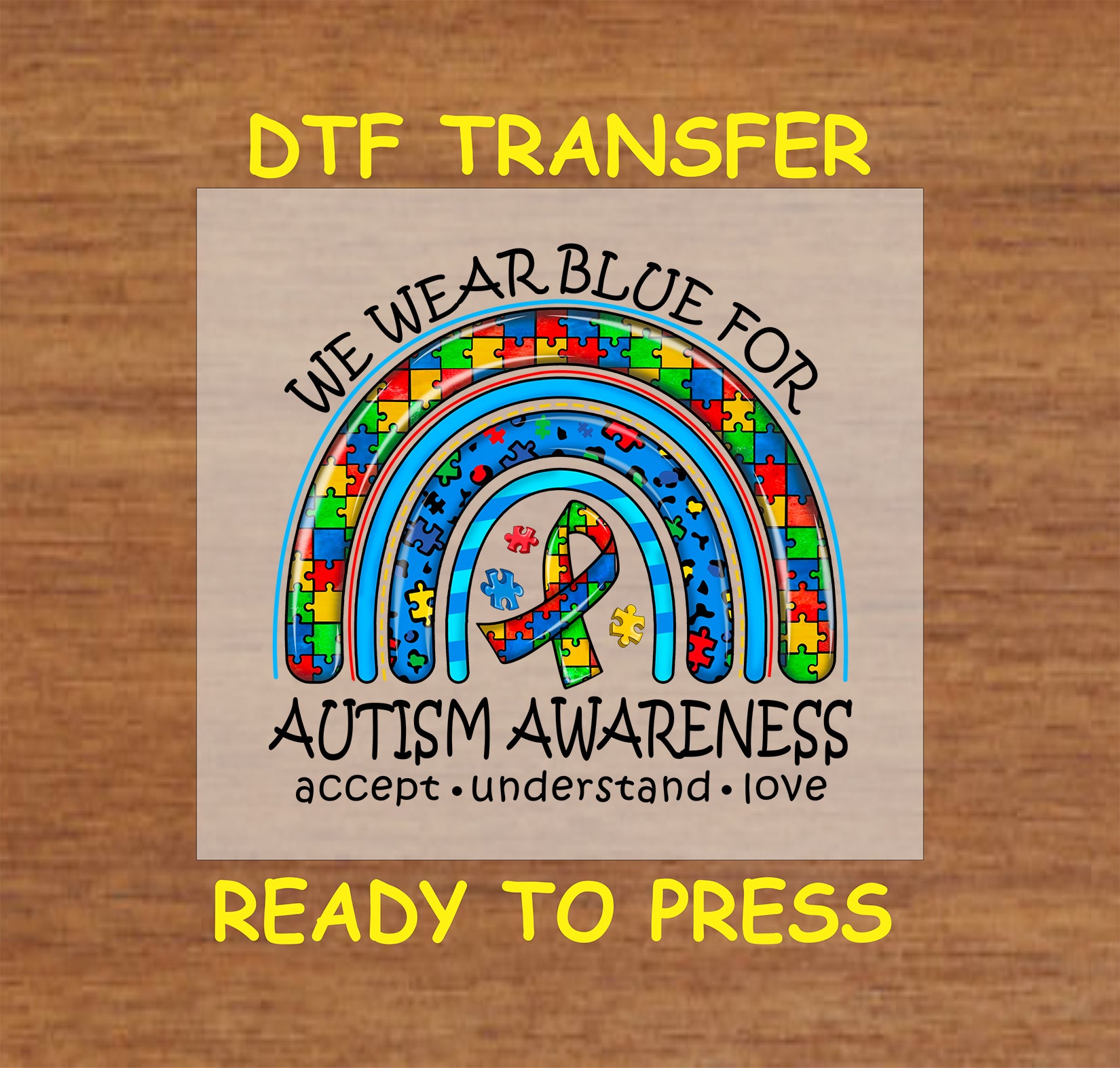 Vibrant "We Wear Blue for Autism Awareness" DTF transfer with a puzzle-piece rainbow and ribbon design.