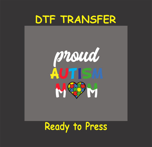"Proud Autism Mom" DTF transfer with vibrant letters and a puzzle heart on a gray background.