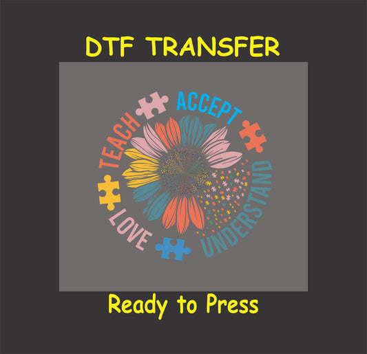 "Teach, Accept, Love, Understand" DTF transfer with a sunflower design and puzzle pieces in bright colors.