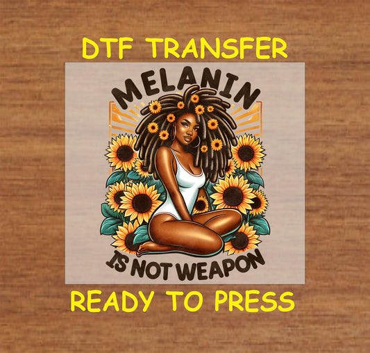 "DTF Transfer design reading 'Melanin Is Not a Weapon,' featuring a Black woman seated among sunflowers, ready to press."