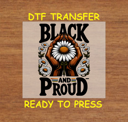 "DTF Transfer design with the text 'Black and Proud,' featuring hands holding a large daisy surrounded by smaller flowers, ready to press."