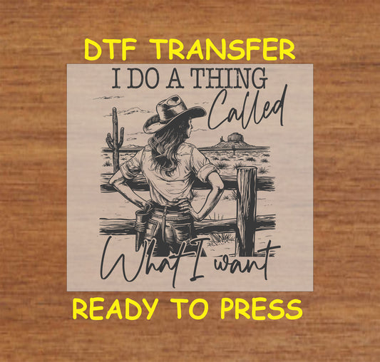 DTF transfer featuring a western cowgirl leaning on a fence with a scenic ranch backdrop and the phrase "I Do a Thing Called What I Want."