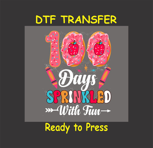 "100 Days Sprinkled with Fun" DTF transfer featuring pink donuts, apples, crayons, and colorful school-themed graphics.