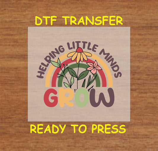 "Helping Little Minds Grow DTF Transfer with floral and rainbow design, perfect for teacher appreciation shirts."