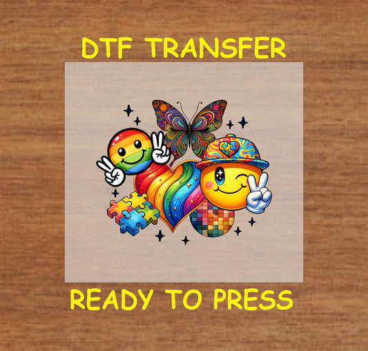 "Autism Acceptance" DTF transfer featuring smiley faces, puzzle pieces, a rainbow heart, and a butterfly design.