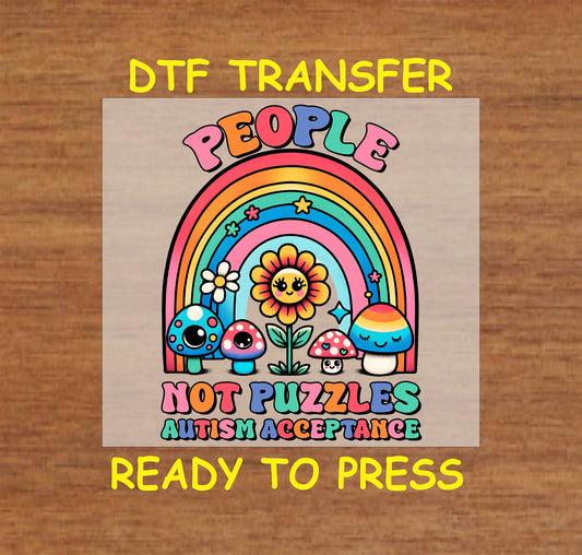 "People Not Puzzles" Autism Acceptance DTF transfer with a rainbow, smiling flower, mushrooms, and bold text.