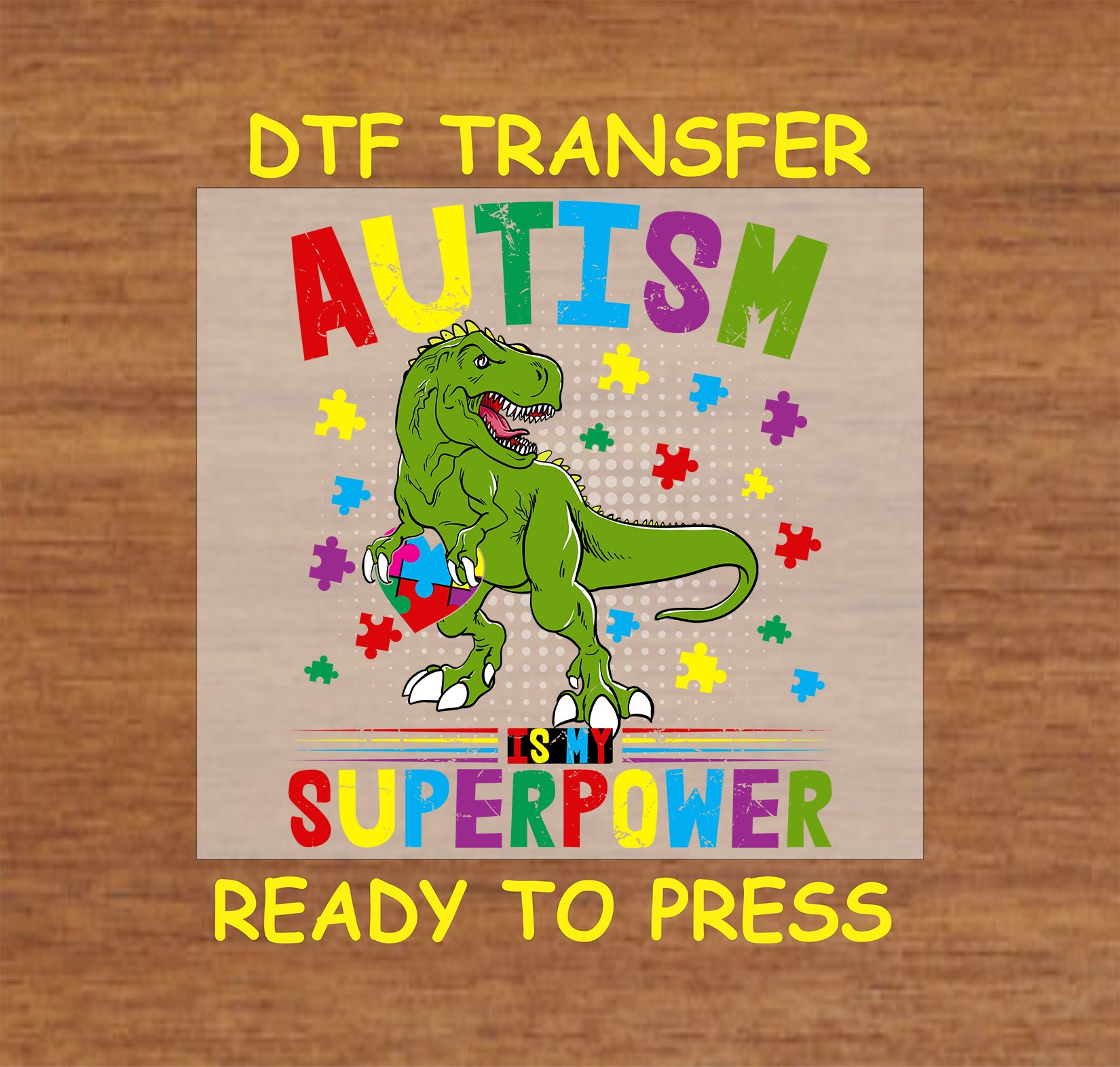 "DTF transfer featuring a dinosaur holding a puzzle piece with the phrase 'AUTISM IS MY SUPERPOWER' surrounded by colorful puzzle pieces."