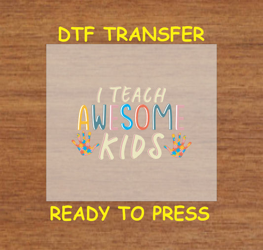 "DTF transfer featuring the phrase 'I Teach Awesome Kids' with colorful letters and handprints with puzzle pieces for autism awareness."