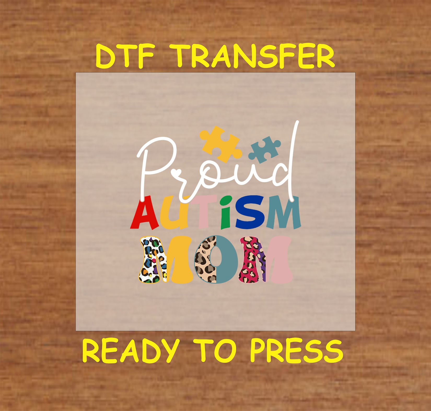 "DTF transfer featuring the phrase 'Proud Autism Mom' with colorful puzzle pieces and leopard print accents."