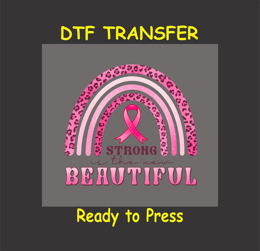 "Strong Is the New Beautiful DTF transfer with a pink leopard rainbow and ribbon, ready to press."