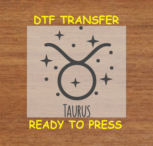 DTF transfer featuring the Taurus zodiac symbol surrounded by stars in a minimalist black design.