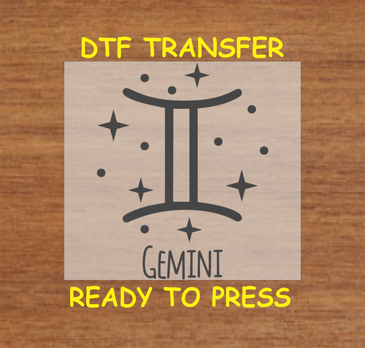 Gemini zodiac DTF transfer featuring the twins symbol and celestial star accents in black.