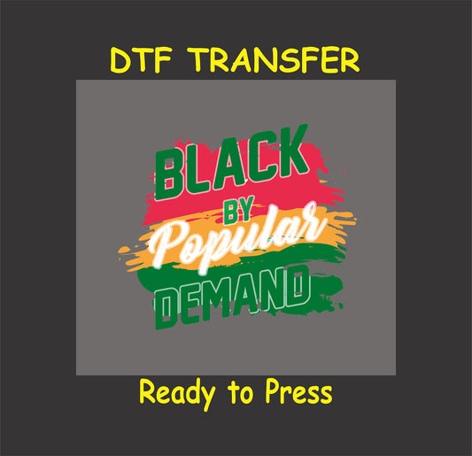 Black By Popular Demand DTF transfer with bold brush stroke design in red, yellow, green, and white, ready to press for custom apparel.