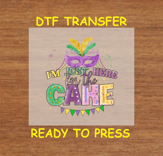 Mardi Gras DTF transfer with a purple mask, festive text, and colorful banner reading "I'm Just Here for the Cake."