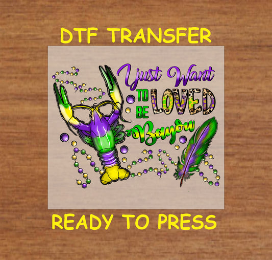 Mardi Gras DTF transfer with a crawfish claw, beads, and a feather.