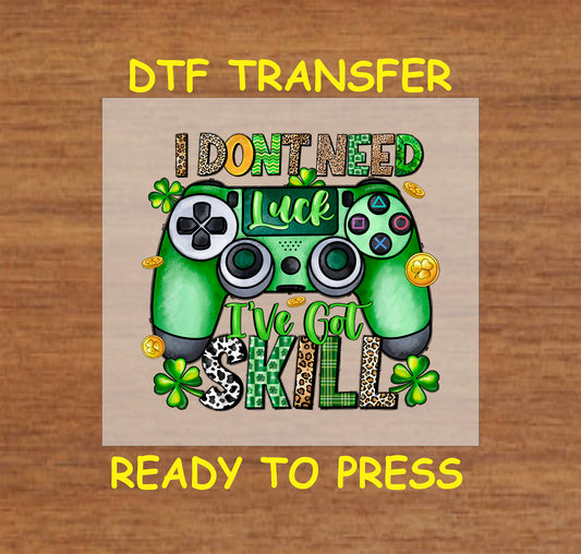St. Patrick’s Day I Don’t Need Luck, I’ve Got Skill DTF transfer with a green gaming controller, shamrocks, and gold coins.