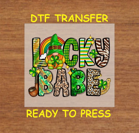 St. Patrick’s Day Lucky Babe DTF transfer with a gnome, shamrocks, and a rainbow.