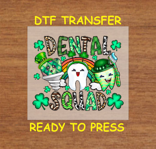 St. Patrick’s Day DTF transfer with "Dental Squad" text, smiling tooth, toothbrush cup, shamrocks, and a rainbow.