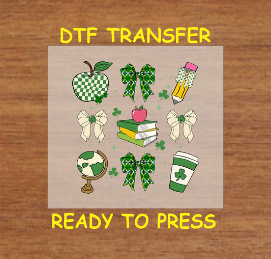 Teacher-themed St. Patrick’s Day DTF transfer with books, bows, apples, pencils, and coffee cup.